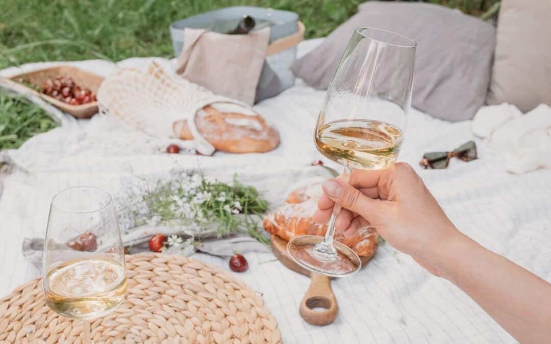 Rustic picnic with wine and croissants, aesthetic picnic. Summer food