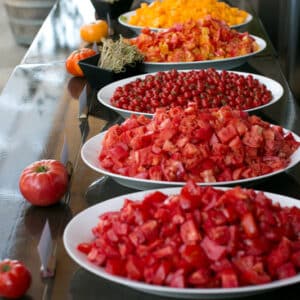 different kinds of tomatoes on plates lined up