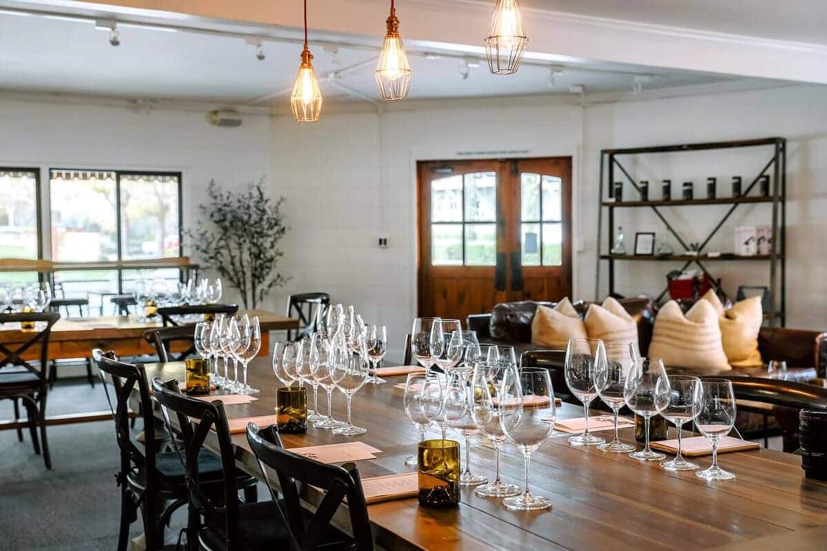 wine tasting room with tables and wine glasses set out
