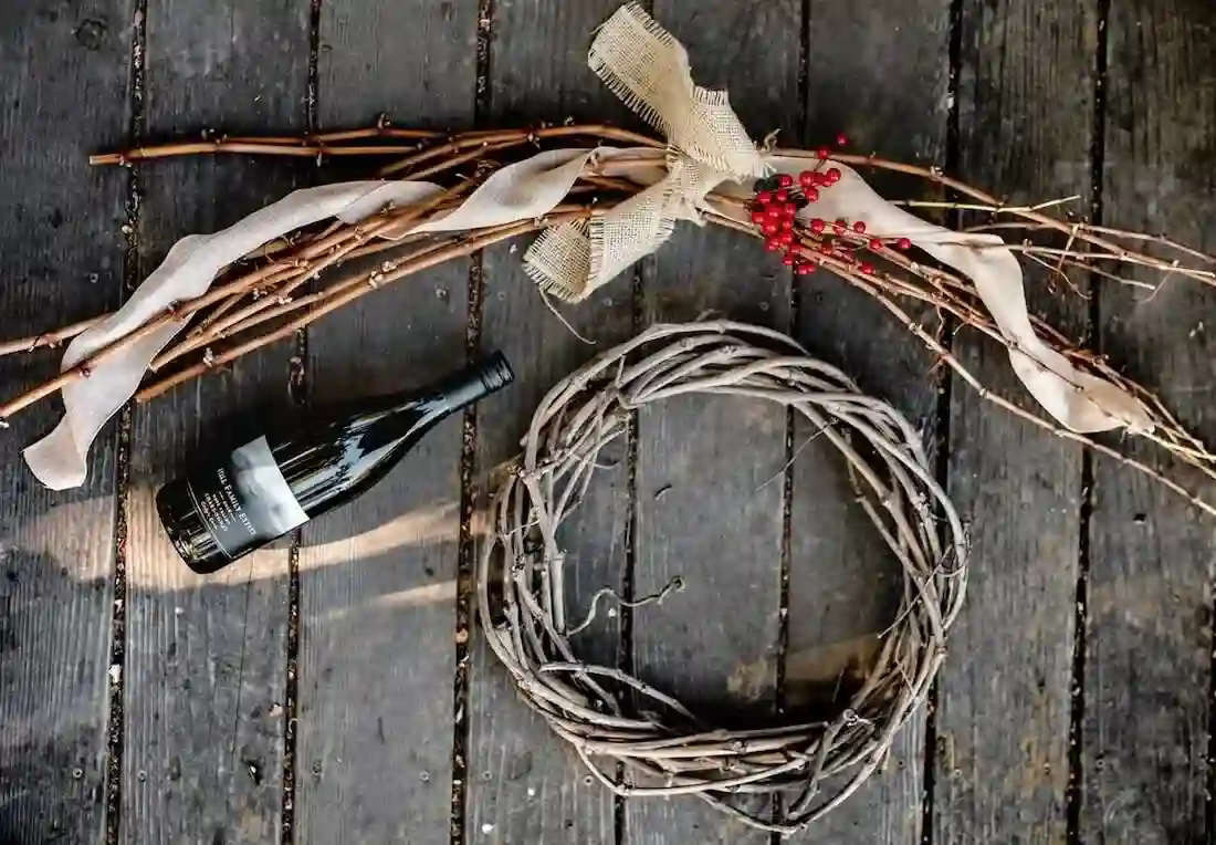 GrapevineWreathmaking (1) hill family estate bottle of wine on table next to wreath made of grape vines